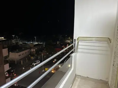 a view of a city at night from a balcony at شقة صغيرة جميلة امام مارينا الغردقة in Hurghada