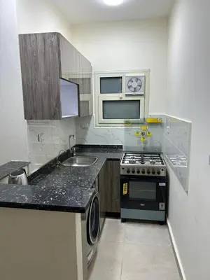 a small kitchen with a stove and a sink at شقة صغيرة جميلة امام مارينا الغردقة in Hurghada
