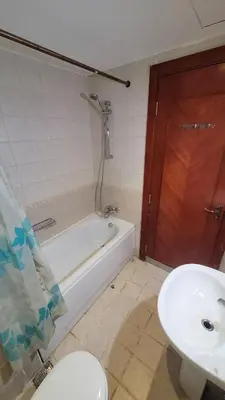 a bathroom with a tub and a sink and a toilet at Amazing Douplex in The View in Hurghada