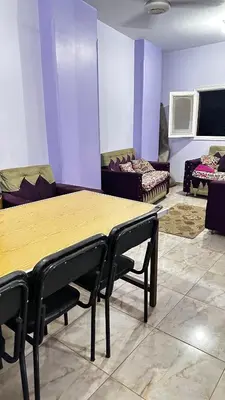 a room with a table and chairs and a couch at Diebo in Aswan
