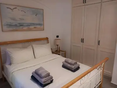 a bedroom with a bed with towels on it at Peaceful & bright lagoon escape - Shared infinity Pool - 1BR - Sabina, El Gouna in Hurghada