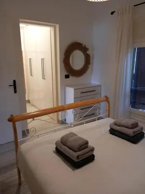 a bedroom with a bed with towels on it at Peaceful & bright lagoon escape - Shared infinity Pool - 1BR - Sabina, El Gouna in Hurghada