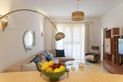 a living room with a bowl of fruit on a table at VESTA - El Gouna Residence in Hurghada