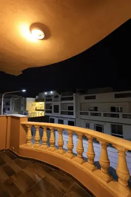 a view from the balcony of a building at night at Magawish Bliss , Elegant Hurghada Apartment in Hurghada