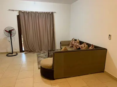 a living room with a couch with pillows on it at One Bedroom Chalet with Side Sea View ,Turtles, Hurghada Concierge D 14 6 in Hurghada