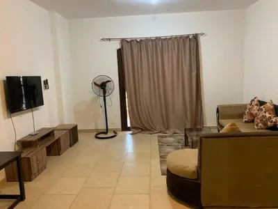 a living room with a couch and a tv at One Bedroom Chalet with Side Sea View ,Turtles, Hurghada Concierge D 14 6 in Hurghada