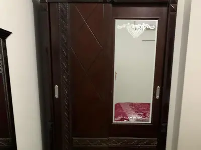 a wooden cabinet with a mirror in a room at One Bedroom Chalet with Side Sea View ,Turtles, Hurghada Concierge D 14 6 in Hurghada