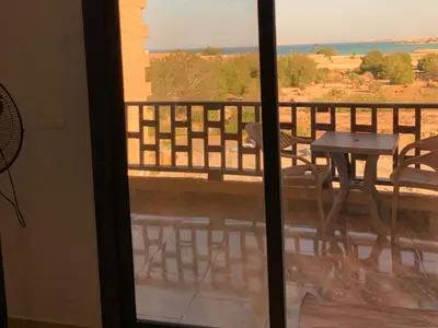 a view of a balcony with a table and chairs at One Bedroom Chalet with Side Sea View ,Turtles, Hurghada Concierge D 14 6 in Hurghada