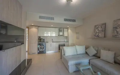 a living room with a couch and a kitchen at New 1BR Apartment in Mangroovy El Gouna Pool, Beach, The Red Sea in Hurghada