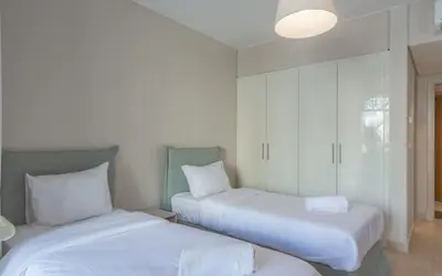 two beds with white sheets in a room at New 1BR Apartment in Mangroovy El Gouna Pool, Beach, The Red Sea in Hurghada