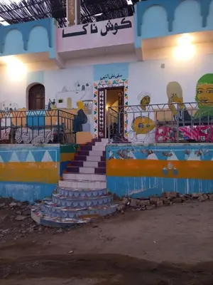 a building with a staircase with a painting on it at Nubian house in Jazīrat Salūjah