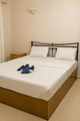 a bed with a blue teddy bear sitting on it at One-Bedroom Chalet at Turtles Beach Resort , Pool & Side Sea View C22 in Hurghada