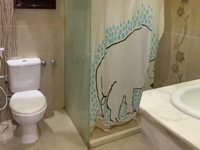 a bathroom with a toilet and a sink at One-Bedroom Chalet with Side Sea View , Turtles Beach C23 in Hurghada