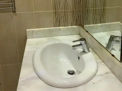 a bathroom with a white sink and a mirror at One-Bedroom Chalet with Side Sea View , Turtles Beach C23 in Hurghada