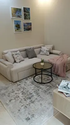 a living room with a couch and a table at Mirage Bay Resort Aquapark SAM Suite in Hurghada