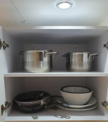 three pots and pans on a shelf in a kitchen at Mirage Bay Resort Aquapark Ghada Suite in Hurghada