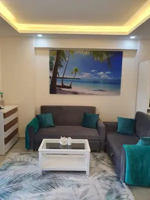 a living room with a couch and a coffee table at Mirage Bay Resort Aquapark Ghada Suite in Hurghada