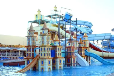 a water park with a castle in the water at Mirage Bay Resort Aquapark Ghada Suite in Hurghada