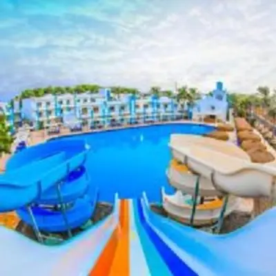a large swimming pool with chairs and a resort at Mirage Bay Resort Aquapark Ghada Suite in Hurghada