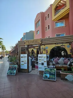 a store with signs in front of a building at Simplestays Hurghada in Hurghada