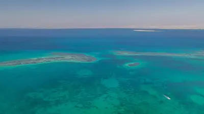 an island in the middle of the ocean at رحلات بحرية دولفين وغواصة وجزر in Hurghada