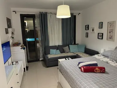a living room with a bed and a couch at Chic G Cribs Studio in El Gouna