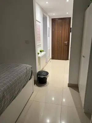 a bedroom with a bed and a hallway with a door at Chic G Cribs Studio in El Gouna