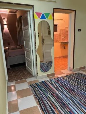 a room with a doorway with a mirror and a bathroom at SolNest Guest House in Jazīrat Aswān