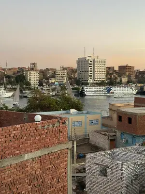 a view of a city with a river and buildings at SolNest Guest House in Jazīrat Aswān