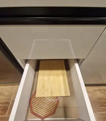 a drawer in a cabinet with a wooden floor underneath it at MARA Apartments Florenza Khamsin in Hurghada