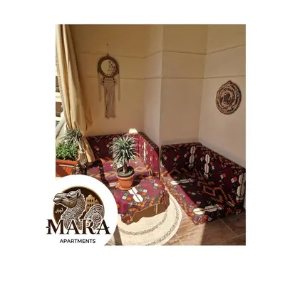 a living room with a couch and a table at MARA Apartments Florenza Khamsin in Hurghada