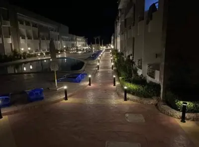 an empty street at night with a swimming pool at Cecilia Resort Hurghada in Hurghada
