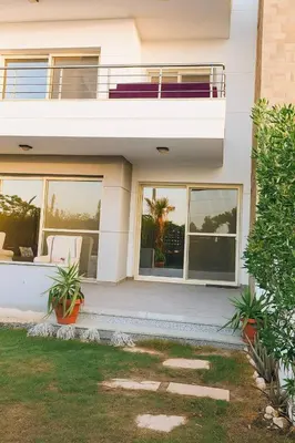 a white house with a porch and a balcony at Hurghada Sky Villa in Hurghada