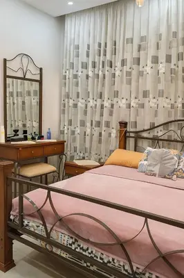 a bedroom with a bed and a desk and a mirror at Hurghada Sky Villa in Hurghada
