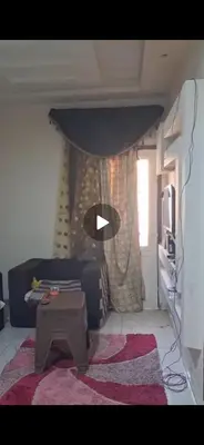 a living room with a couch and a table at Aswan in Naj‘ al Maḩaţţah