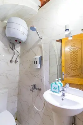 a bathroom with a white sink and a shower at Casa Nile View rooms - Nubian House -by kerma hospitality in Aswan