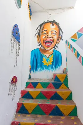 a cake with a painting of a child on a wall at Casa Nile View rooms - Nubian House -by kerma hospitality in Aswan