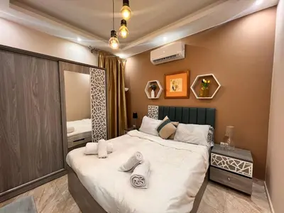 a bedroom with a large bed with towels on it at 2bedroom in selena bay resort in Hurghada