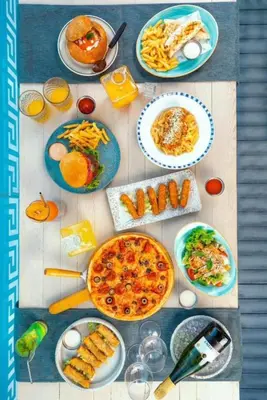 a table topped with plates of food and drinks at 2bedroom in selena bay resort in Hurghada