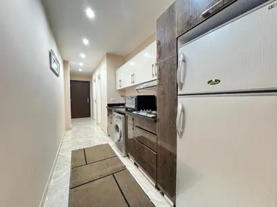 a kitchen with a refrigerator and a stove at 2bedroom in selena bay resort in Hurghada