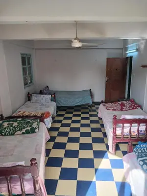 a room with three beds and a checkered floor at New Alsalam Hotel in Luxor