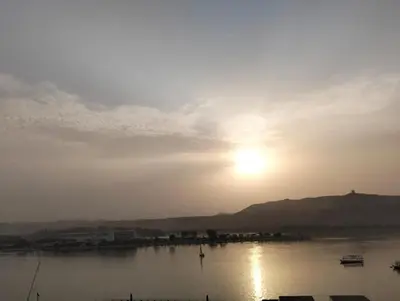 a view of the sun setting over a body of water at اسوان مول بلازا in Aswān