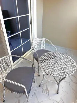 two wicker chairs and a table on a porch at Large Studio Beach & Pool Hurghada - Wifi in Hurghada