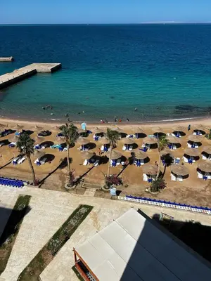 an aerial view of a beach with umbrellas and the ocean at Large Studio Beach & Pool Hurghada - Wifi in Hurghada