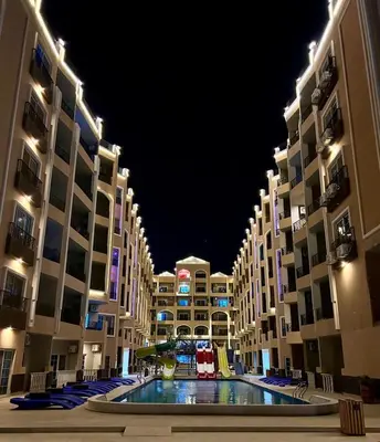 a large building with a pool in the middle at Large Studio Beach & Pool Hurghada - Wifi in Hurghada