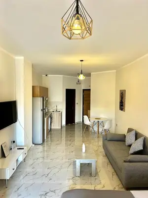 a living room with a couch and a table at Large Studio Beach & Pool Hurghada - Wifi in Hurghada