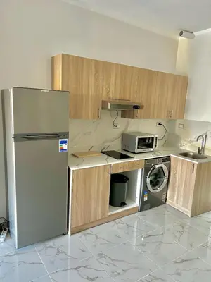 a kitchen with a refrigerator and a washing machine at Large Studio Beach & Pool Hurghada - Wifi in Hurghada