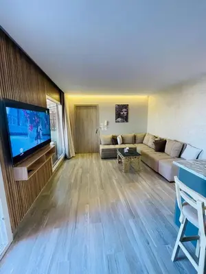 a living room with a couch and a flat screen tv at New Marina Luxury Suite in Hurghada