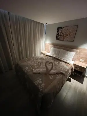 a room with a bed with a heart on it at New Marina Luxury Suite in Hurghada