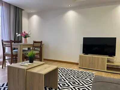 a living room with a large flat screen tv at Cozy One bedroom old town tawaya Sahel hashish in Hurghada